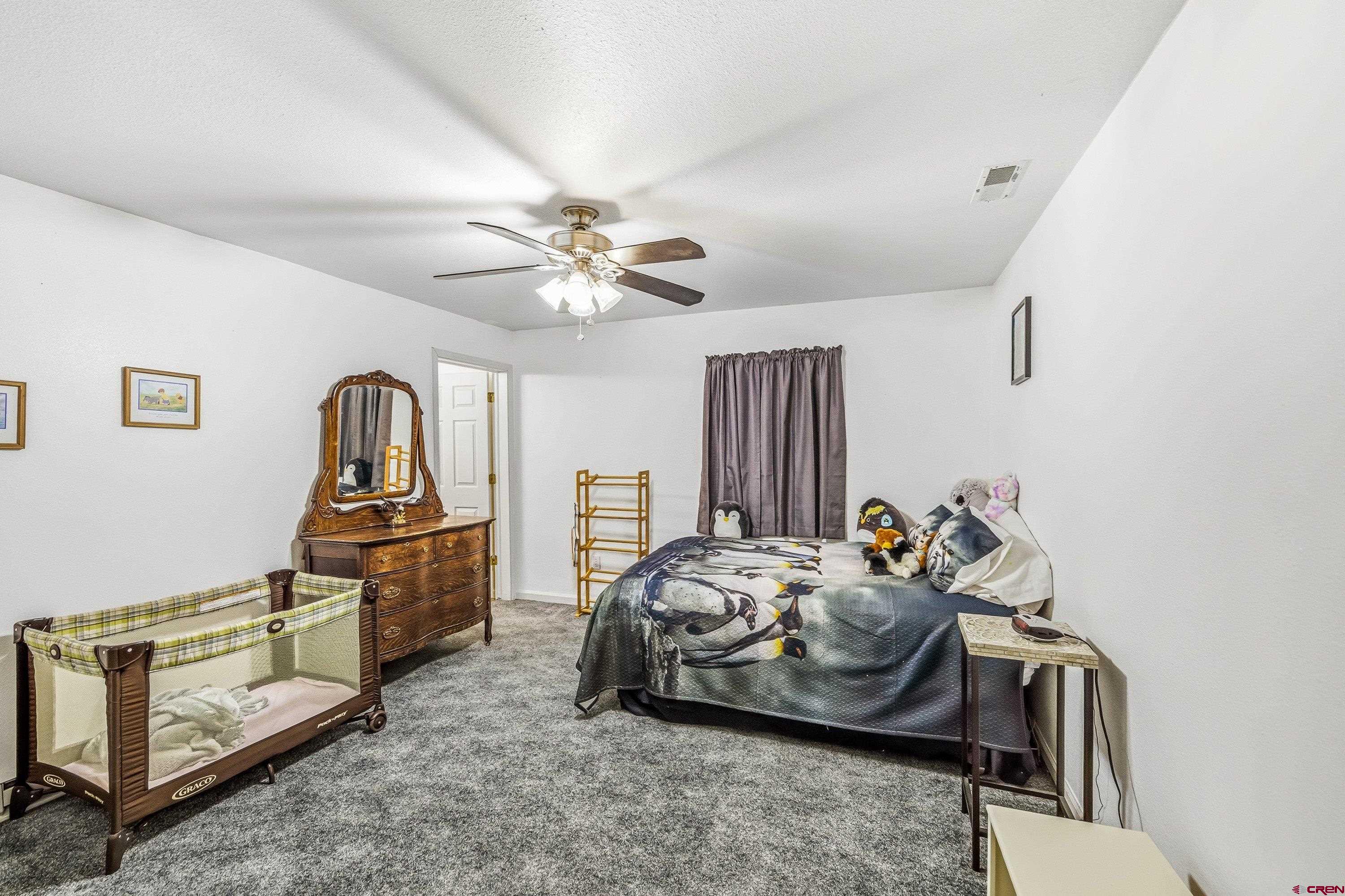 14414 G Road Delta, CO 81416 - Photo 19 of 39 a bedroom with furniture and natural light