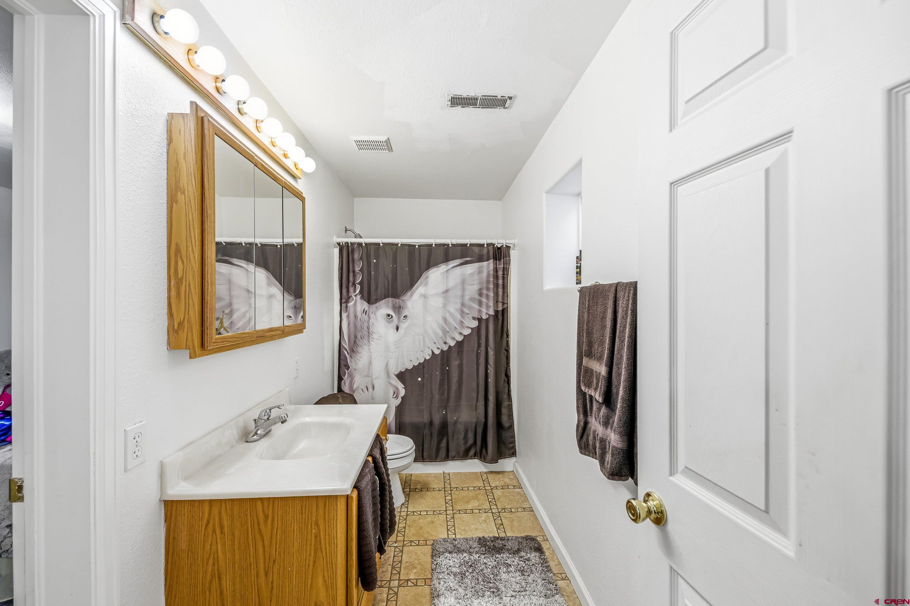 14414 G Road Delta, CO 81416 - Photo 2 of 39 a bathroom with a sink and mirror with bathtub