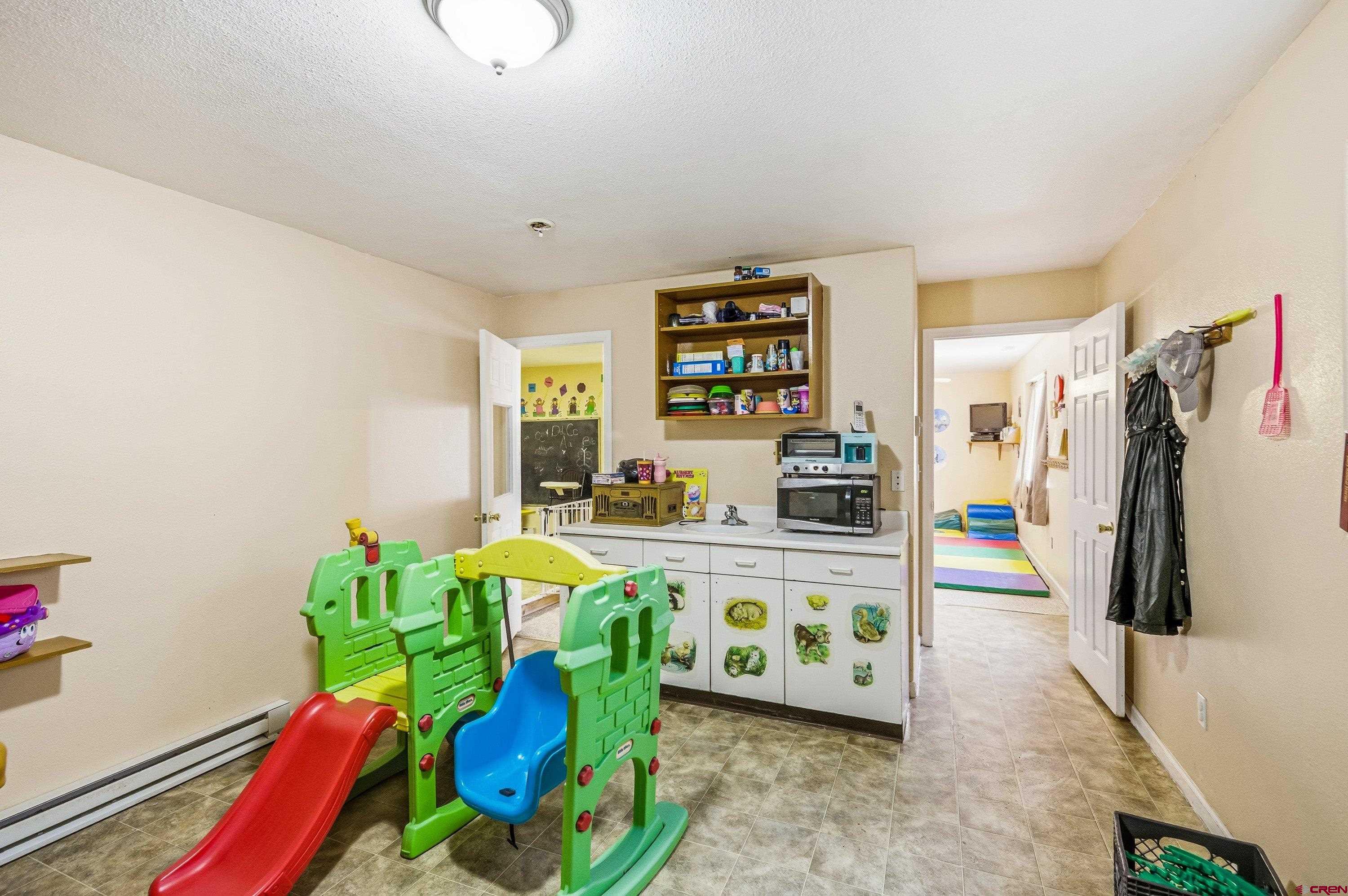 14414 G Road Delta, CO 81416 - Photo 24 of 39 a living room with lots of furniture and gym equipment