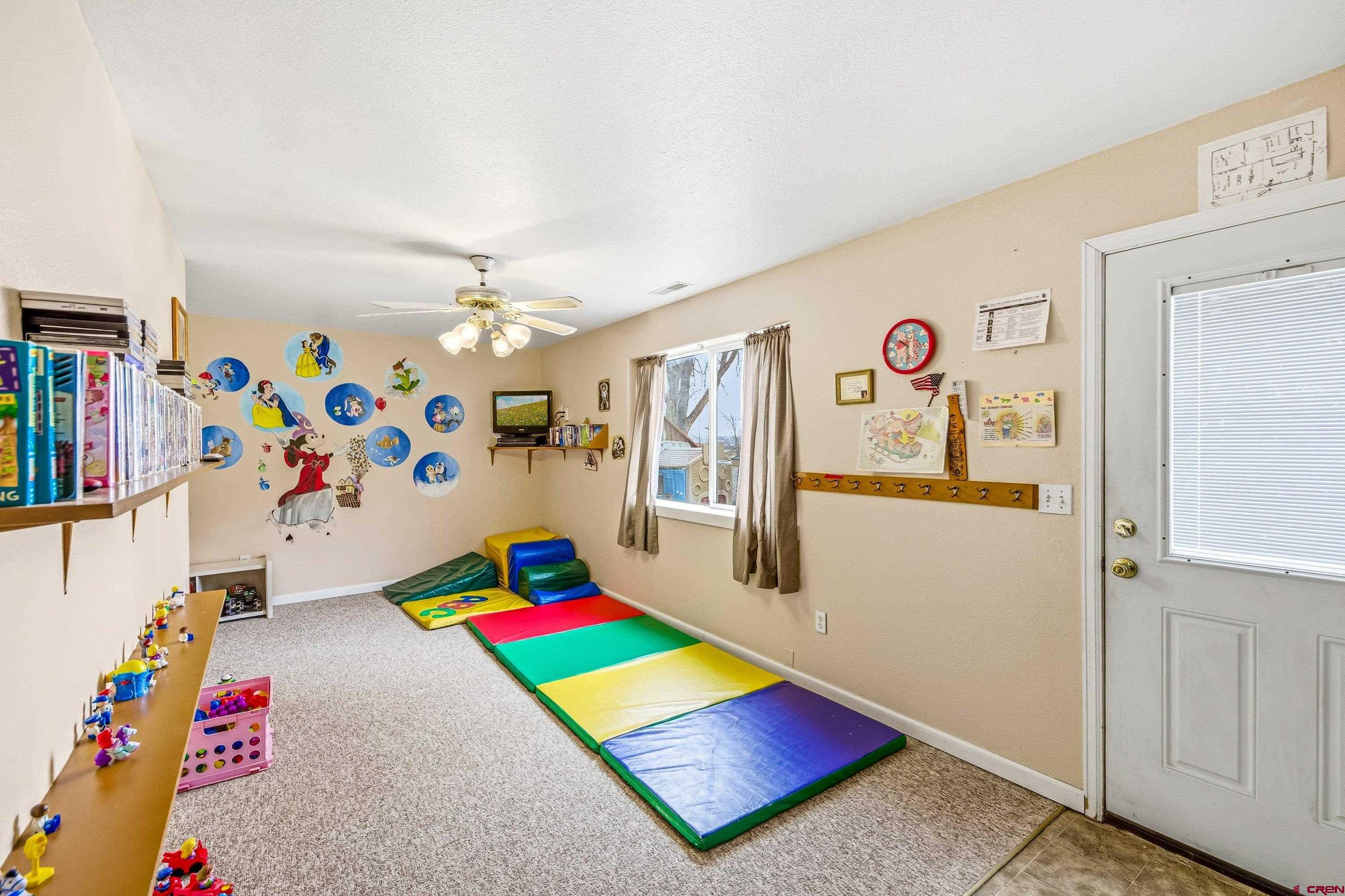 14414 G Road Delta, CO 81416 - Photo 25 of 39 a room with toys and a chandelier