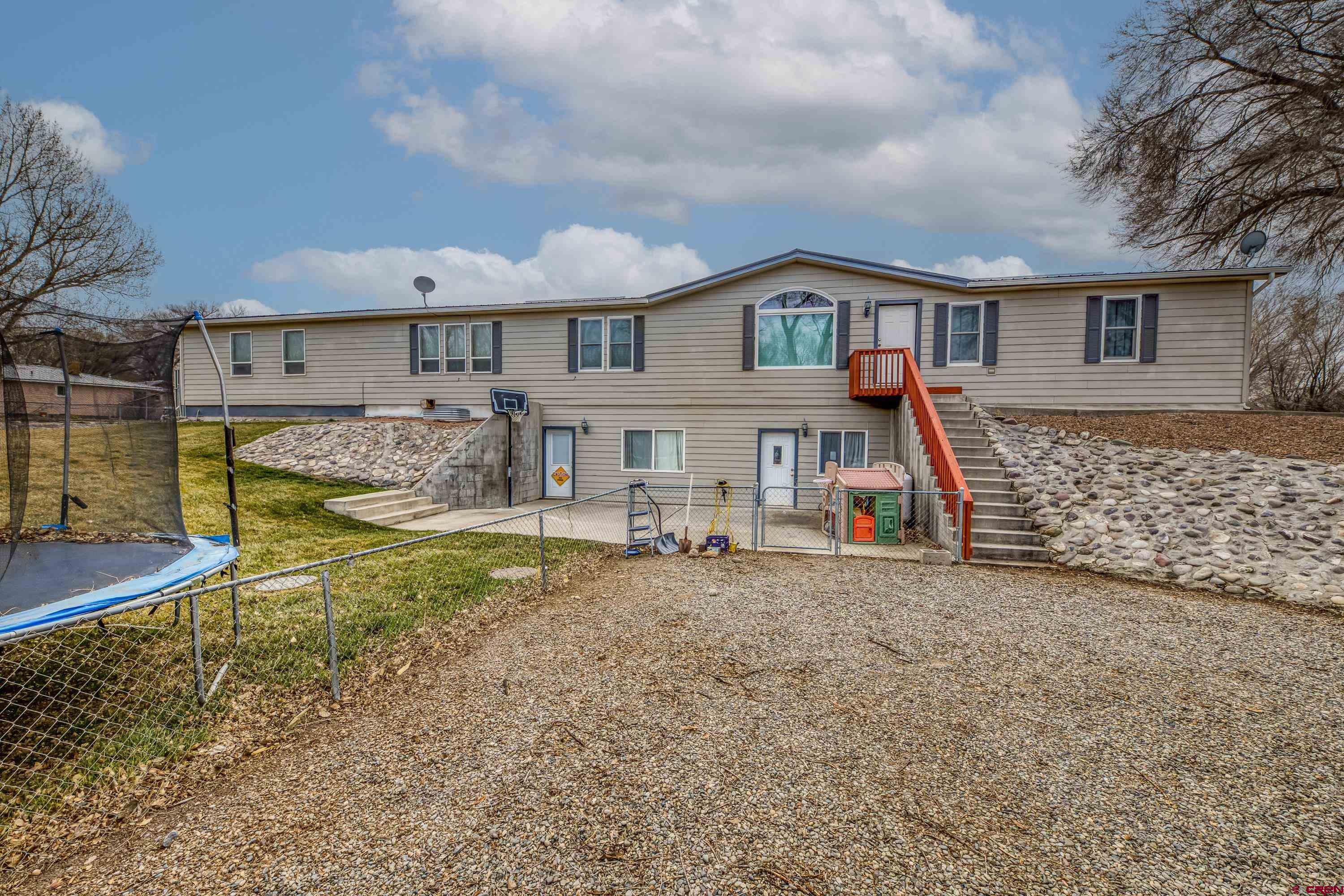 14414 G Road Delta, CO 81416 - Photo 28 of 39 a view of a house with a yard
