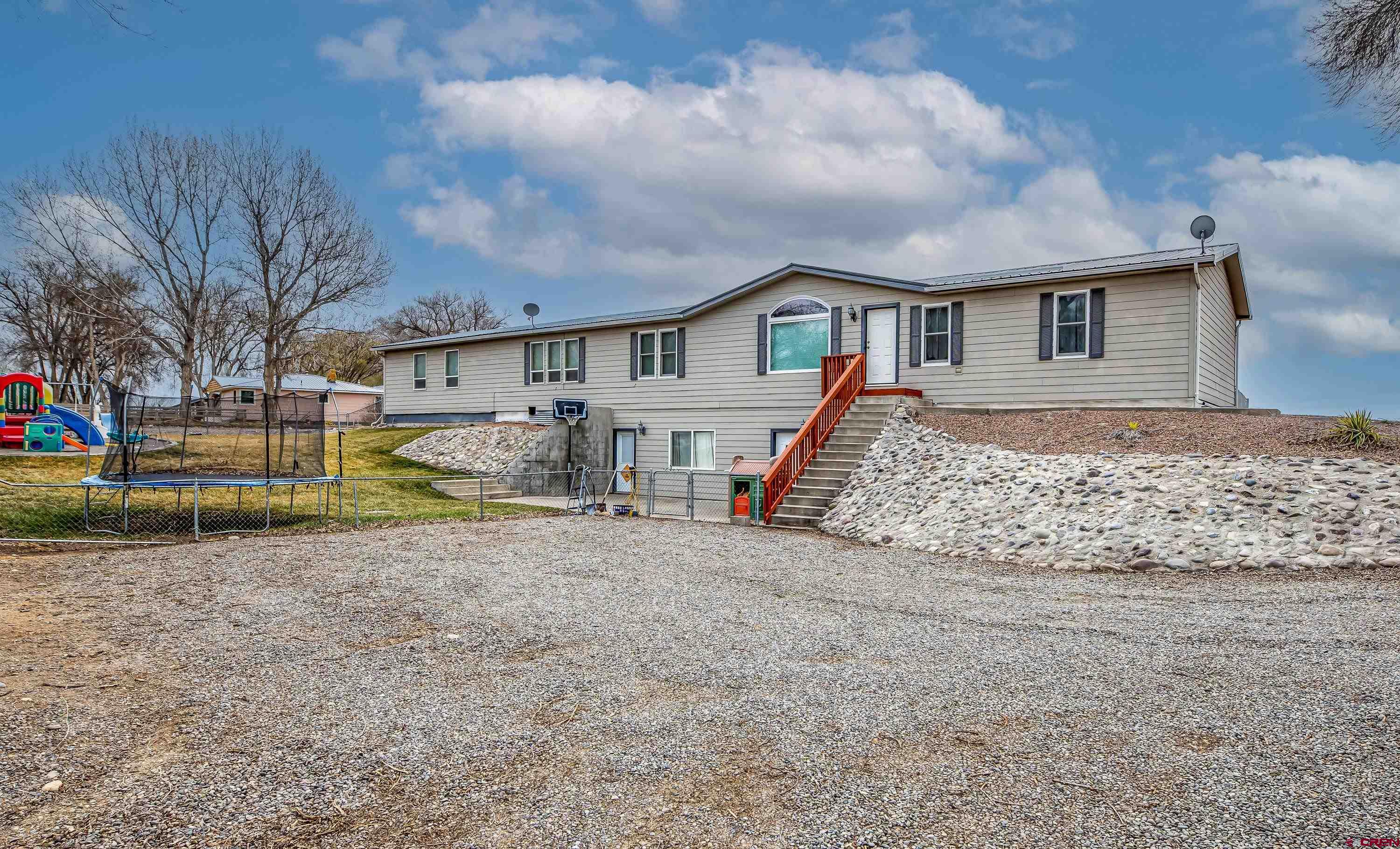 14414 G Road Delta, CO 81416 - Photo 29 of 39 a view of a house with a yard