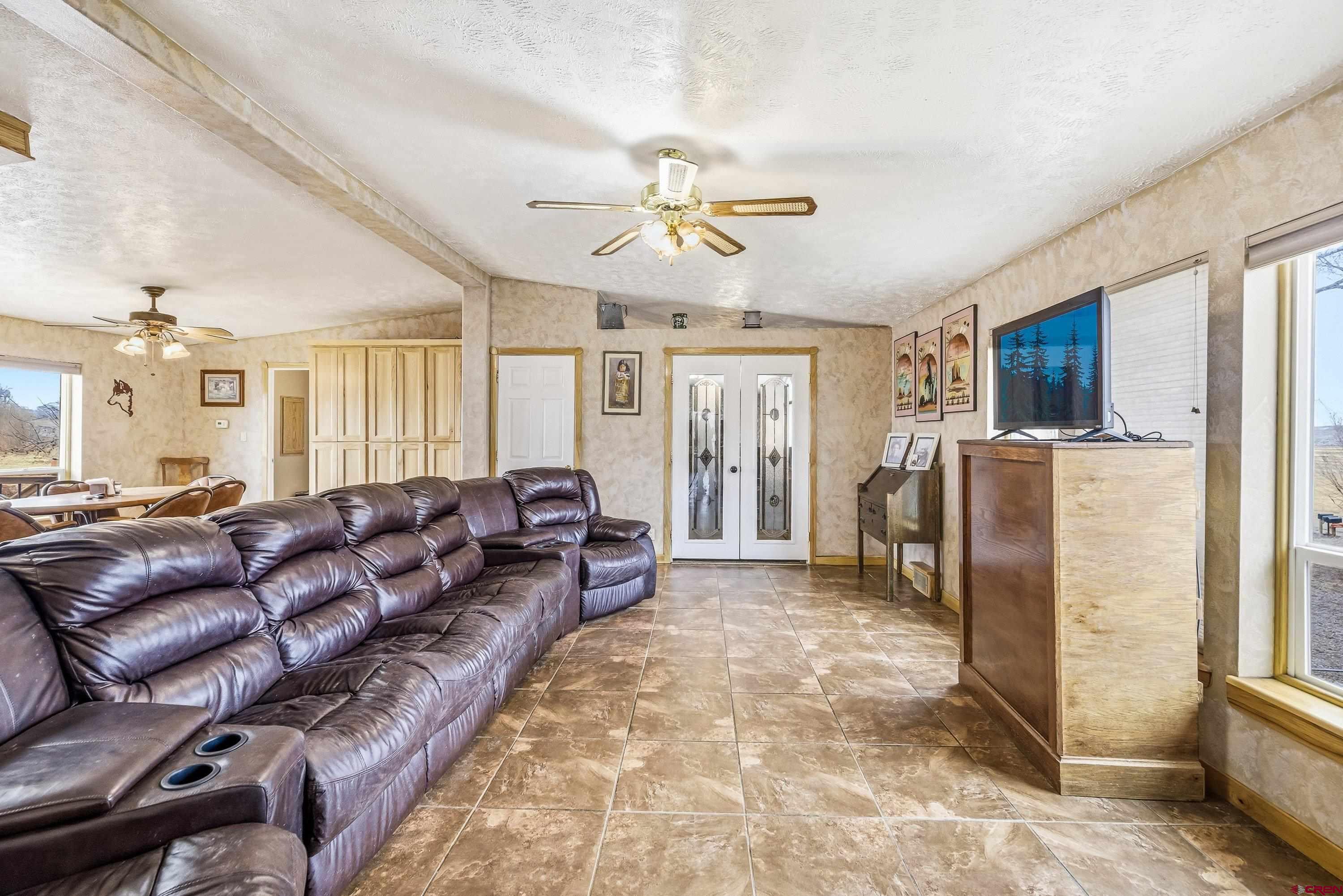 14414 G Road Delta, CO 81416 - Photo 31 of 39 a living room with lots of furniture and a chandelier