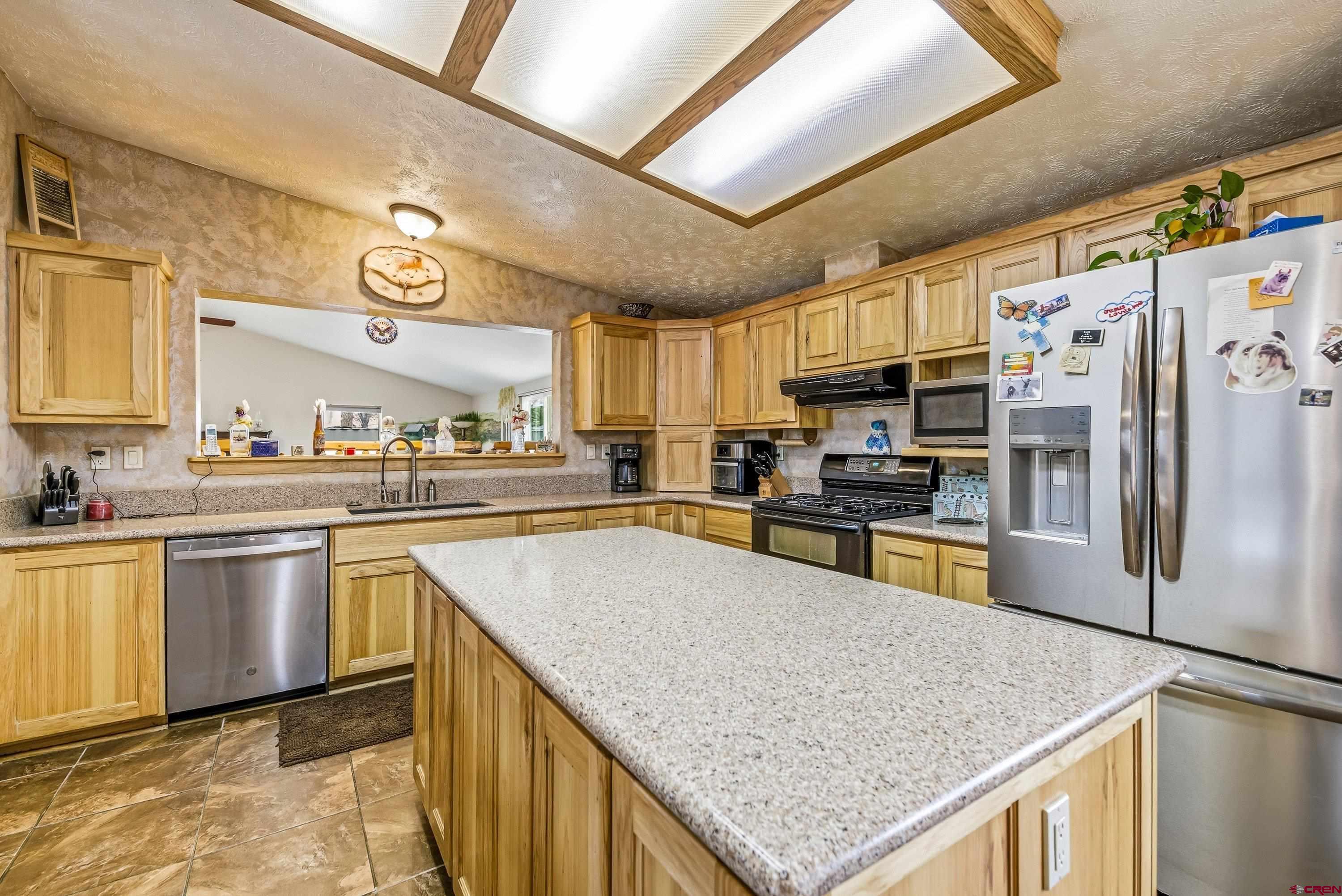 14414 G Road Delta, CO 81416 - Photo 35 of 39 a kitchen with stainless steel appliances granite countertop a sink stove and refrigerator