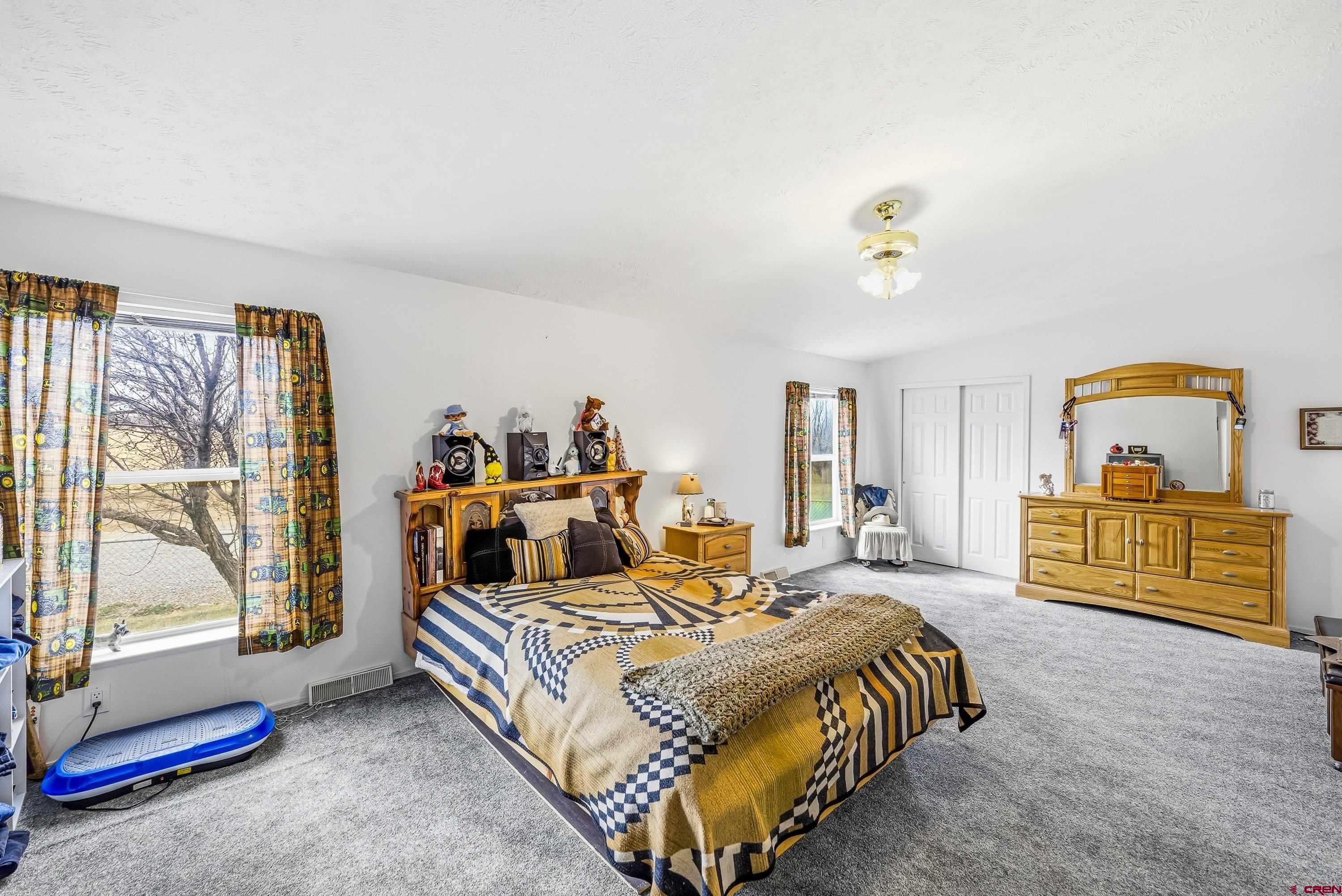 14414 G Road Delta, CO 81416 - Photo 9 of 39 a bedroom with a bed and large windows