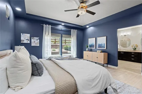 a bedroom with a large bed and a chandelier