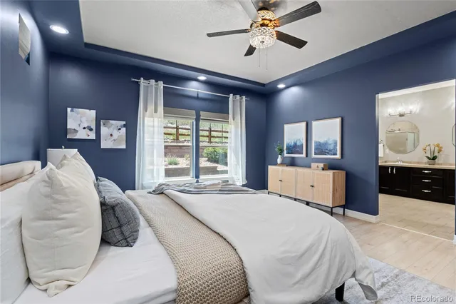 a bedroom with a large bed and a chandelier