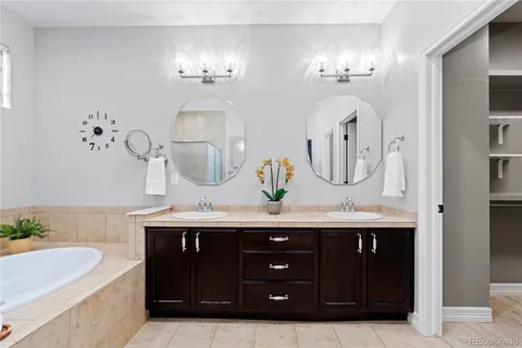 a bathroom with a double vanity sink and a mirror