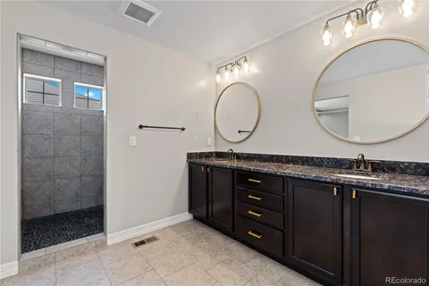 a bathroom with a double vanity sink and a mirror