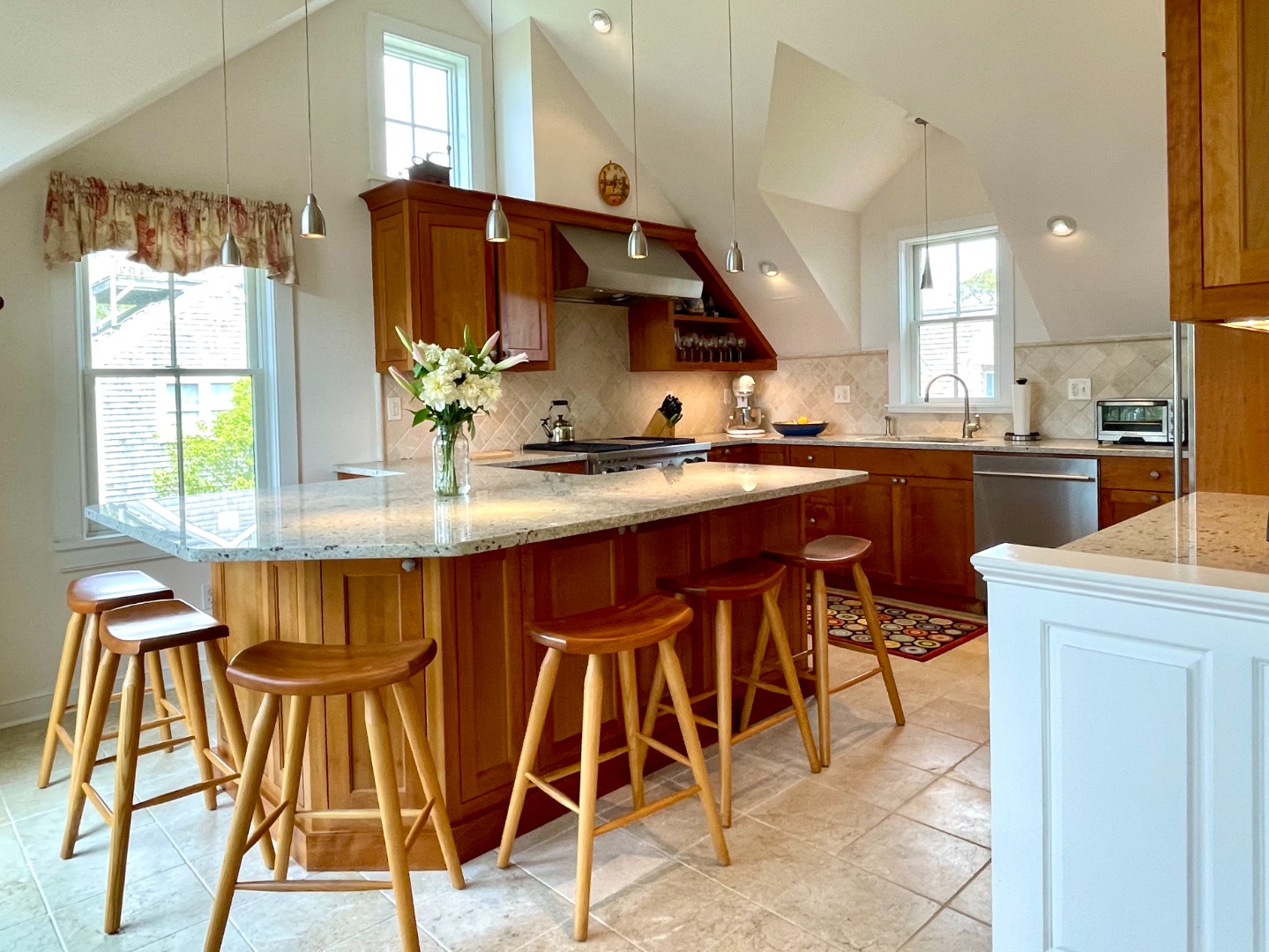 155 Surfside Road Nantucket, MA 02554 - Photo 5 of 60 a kitchen with stainless steel appliances kitchen island granite countertop a table chairs in it and a window