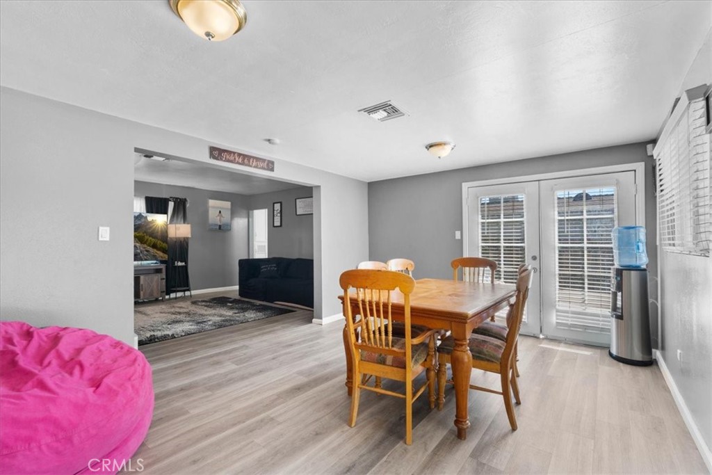 1417 West Marshall Boulevard San Bernardino, CA 92405 - Photo 17 of 39 a view of a dining room with furniture and wooden floor