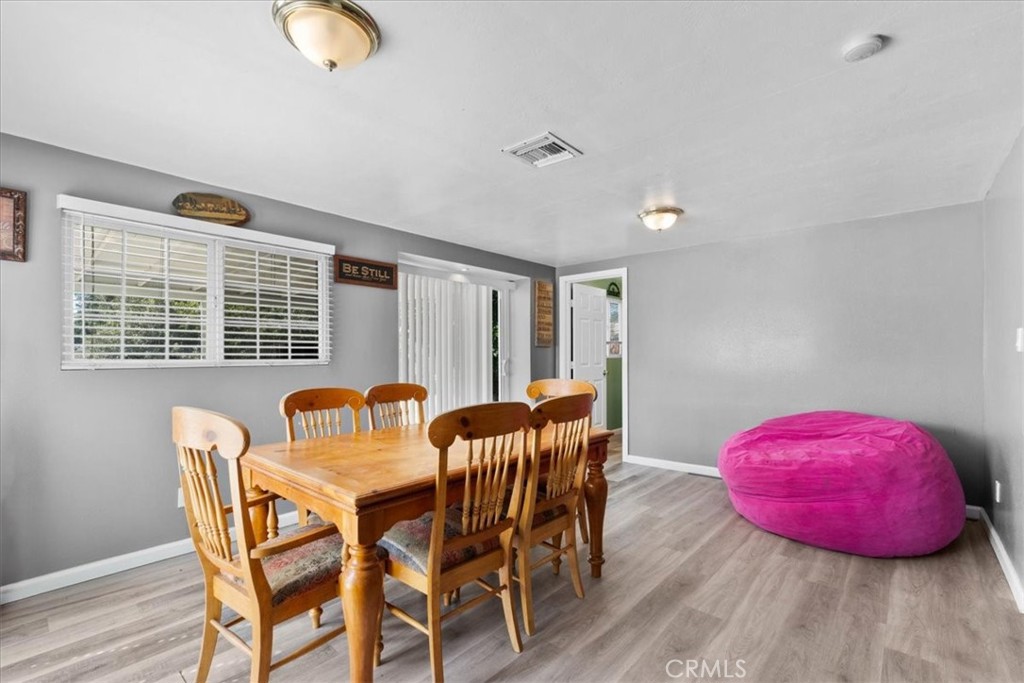 1417 West Marshall Boulevard San Bernardino, CA 92405 - Photo 18 of 39 a view of a dining room with furniture and wooden floor