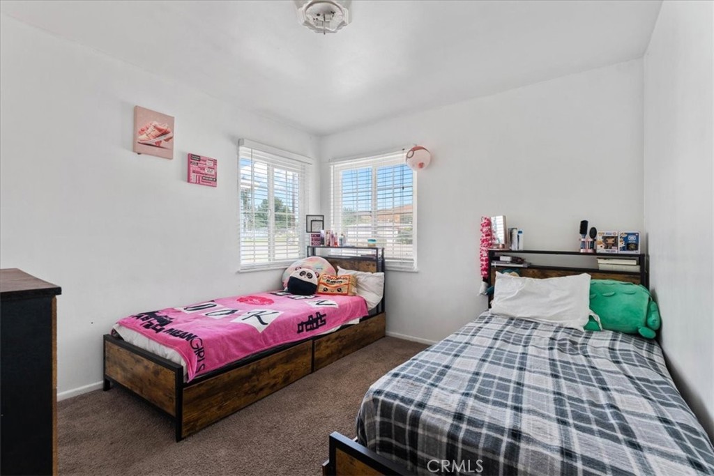 1417 West Marshall Boulevard San Bernardino, CA 92405 - Photo 21 of 39 a bedroom with two beds and a window