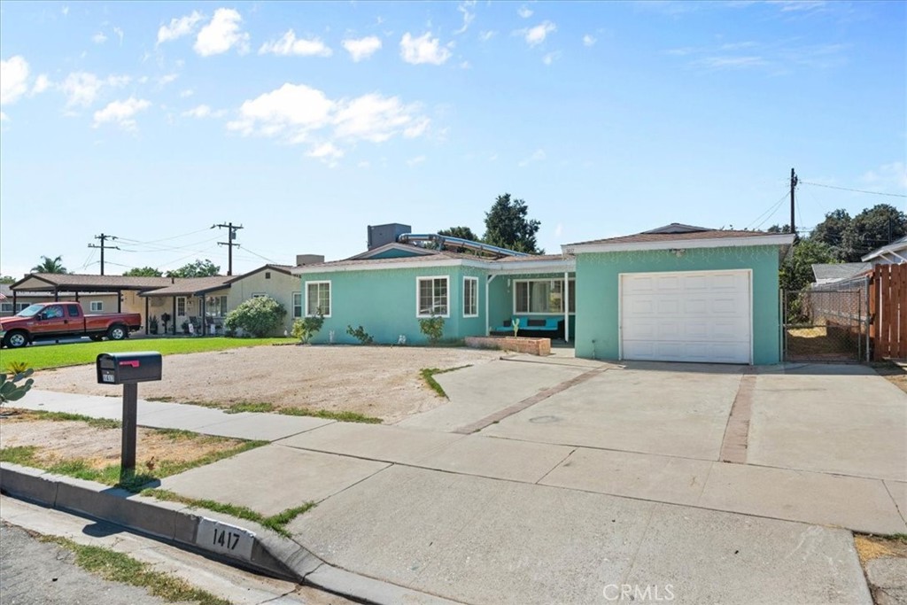 1417 West Marshall Boulevard San Bernardino, CA 92405 - Photo 4 of 39 a view of a house with a yard and potted plants