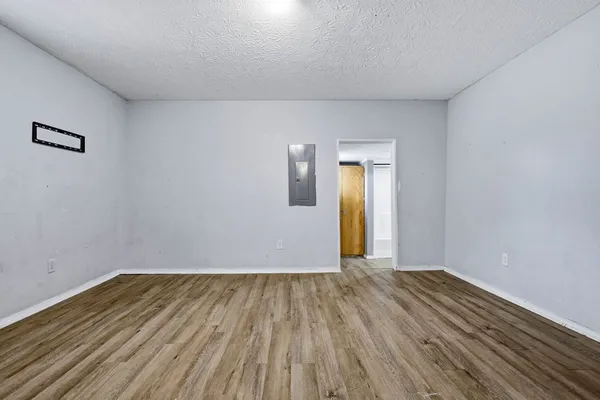 a view of a room with wooden floor and a window