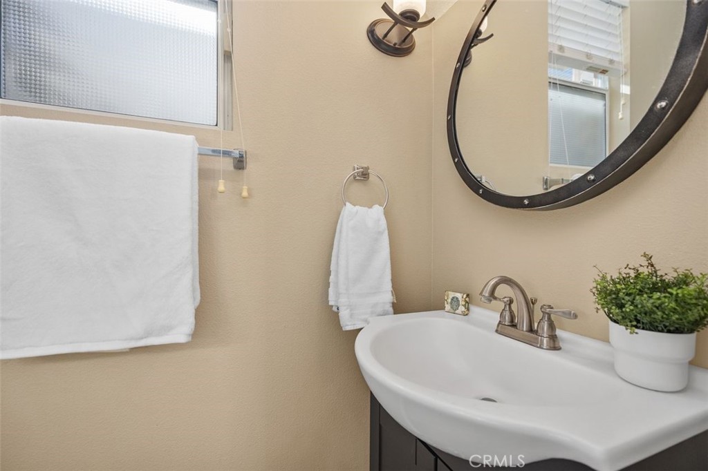 8 Tradition Lane Rancho Santa Margarita, CA 92688 - Photo 12 of 43 a bathroom with a sink and a mirror
