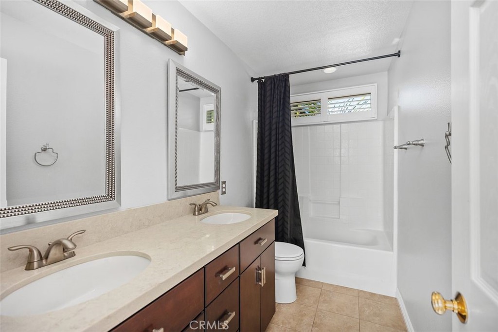 8 Tradition Lane Rancho Santa Margarita, CA 92688 - Photo 14 of 43 a bathroom with a sink a toilet and shower