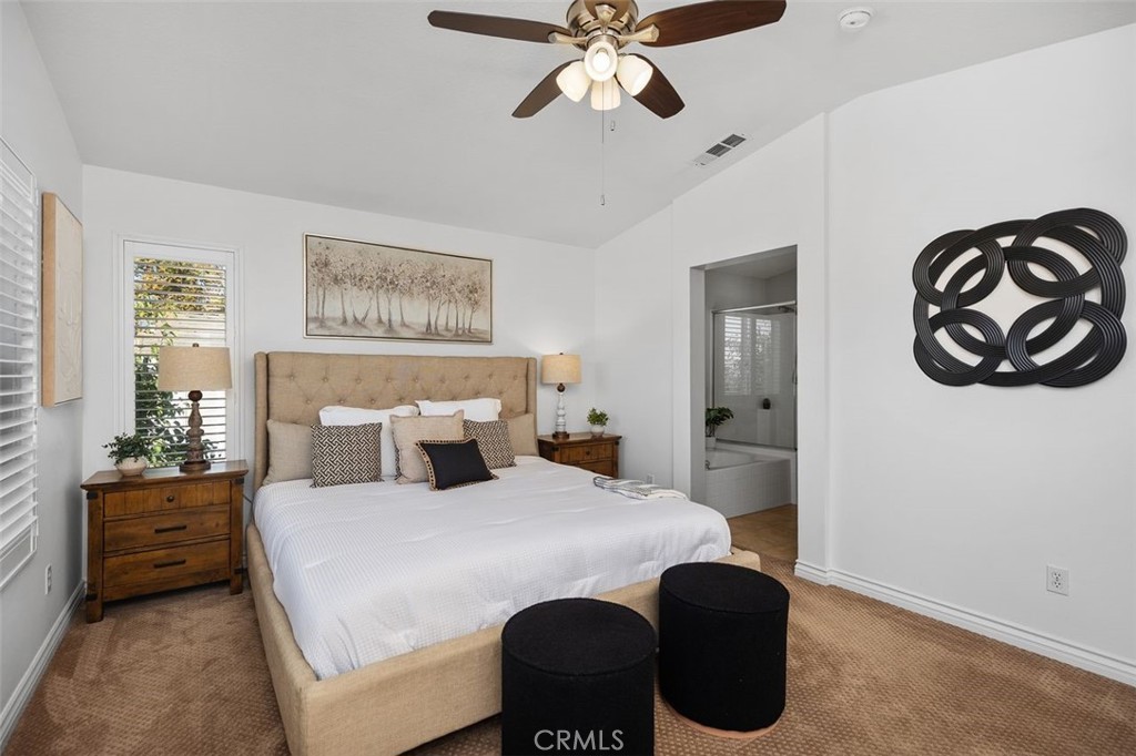 8 Tradition Lane Rancho Santa Margarita, CA 92688 - Photo 19 of 43 a bedroom with a bed and a chandelier