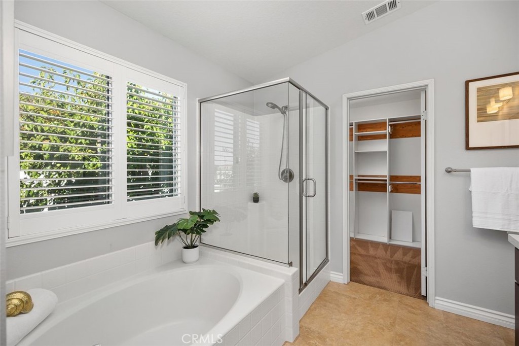 8 Tradition Lane Rancho Santa Margarita, CA 92688 - Photo 21 of 43 a white bath tub sitting in a bathroom next to a window