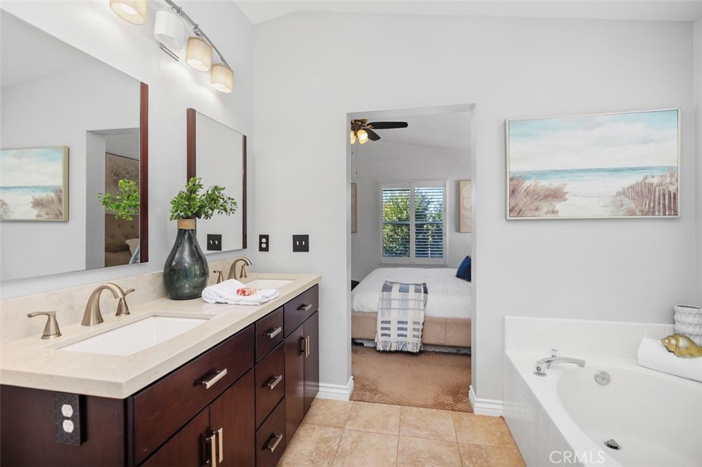 8 Tradition Lane Rancho Santa Margarita, CA 92688 - Photo 23 of 43 a bathroom with a tub double vanity sink and mirror