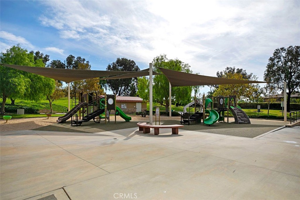 8 Tradition Lane Rancho Santa Margarita, CA 92688 - Photo 32 of 43 a view of a patio with a table and chairs under an umbrella