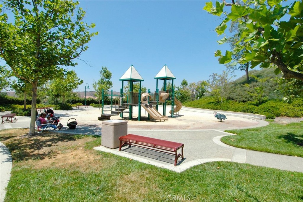 8 Tradition Lane Rancho Santa Margarita, CA 92688 - Photo 40 of 43 a view of a patio with table and chairs potted plants and a large tree