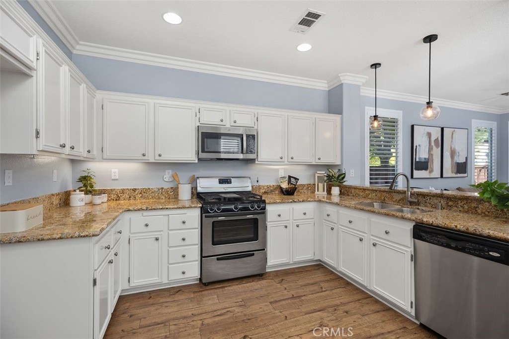 8 Tradition Lane Rancho Santa Margarita, CA 92688 - Photo 6 of 43 a kitchen with granite countertop a sink a stove and cabinets