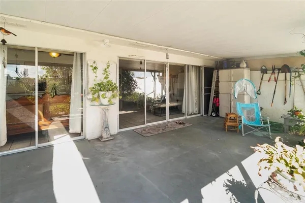 a view of backyard of house with outdoor seating