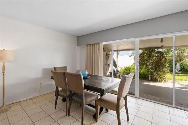 a living room with furniture a table and a large window