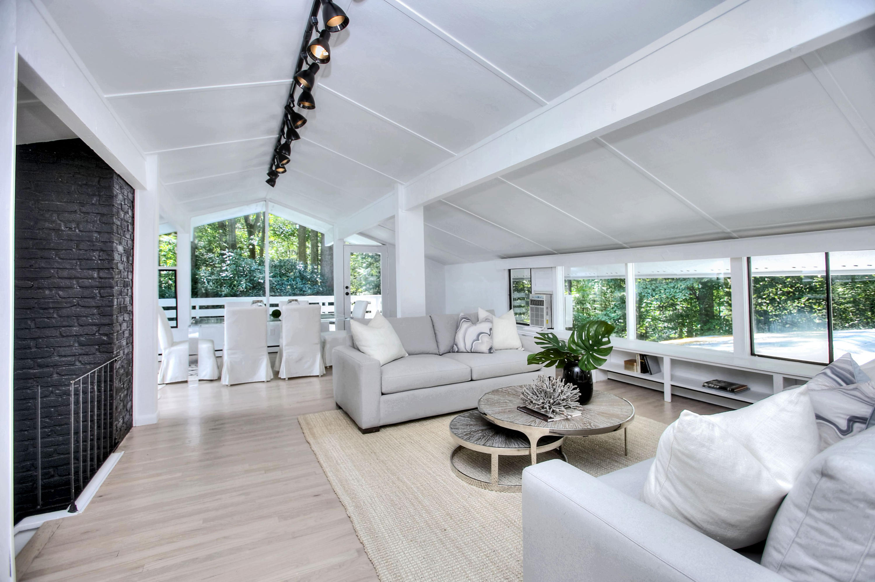1160 Smith Ridge Road New Canaan, CT 06840 - Photo 14 of 32 a living room with furniture large windows and wooden floor