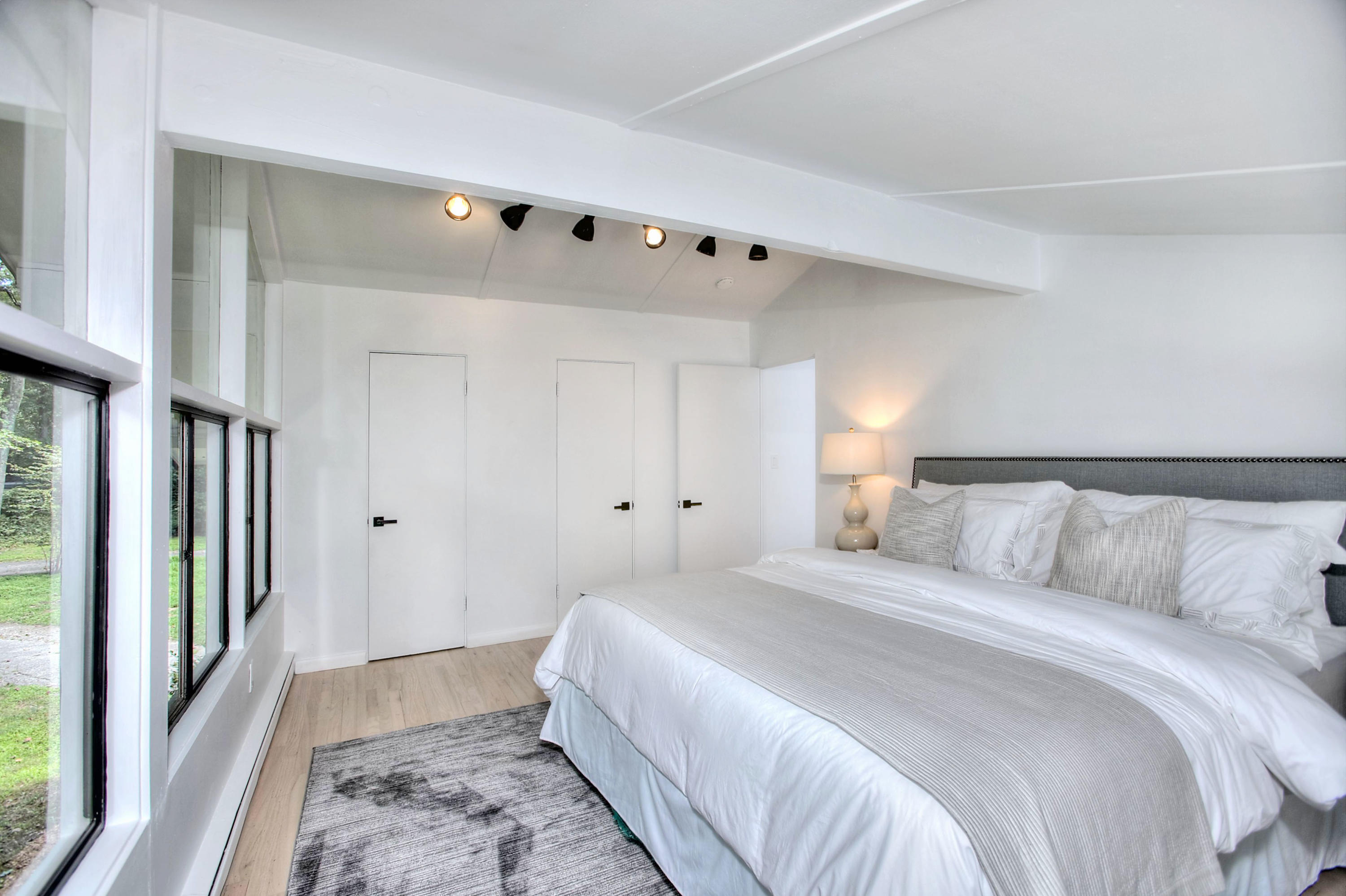 1160 Smith Ridge Road New Canaan, CT 06840 - Photo 22 of 32 a spacious bedroom with a bed and a window