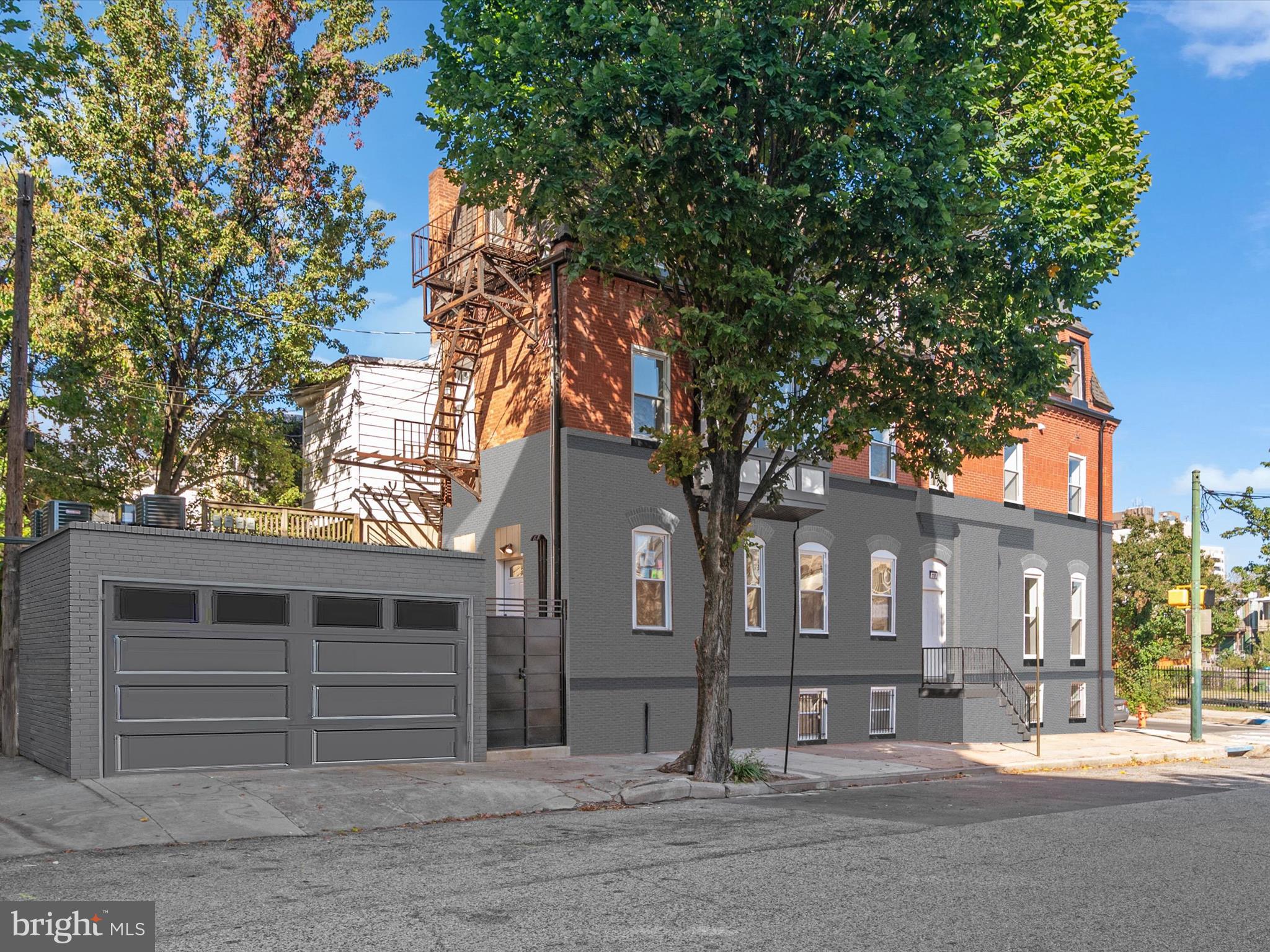 118 East 24th Street, Unit 2 Baltimore, MD 21218 - Photo 12 of 15 a front view of a house with a tree