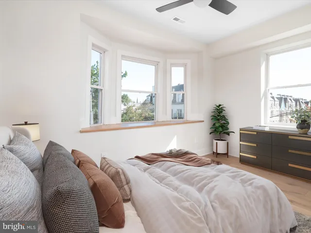 a bedroom with a large bed and a window