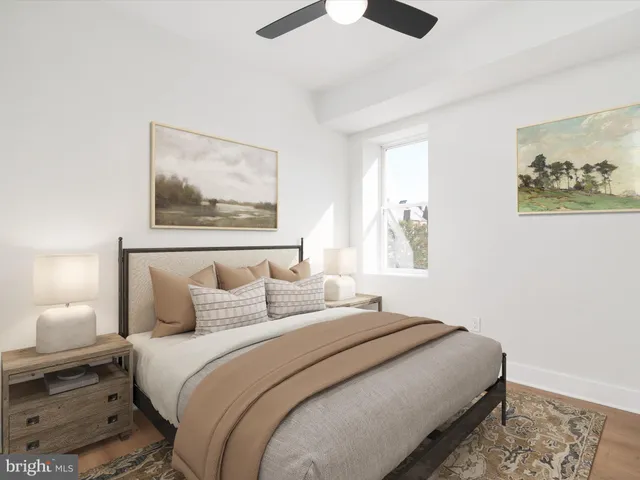 a bedroom with bed and painting on the wall