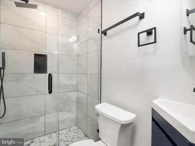 a bathroom with a toilet a sink and shower