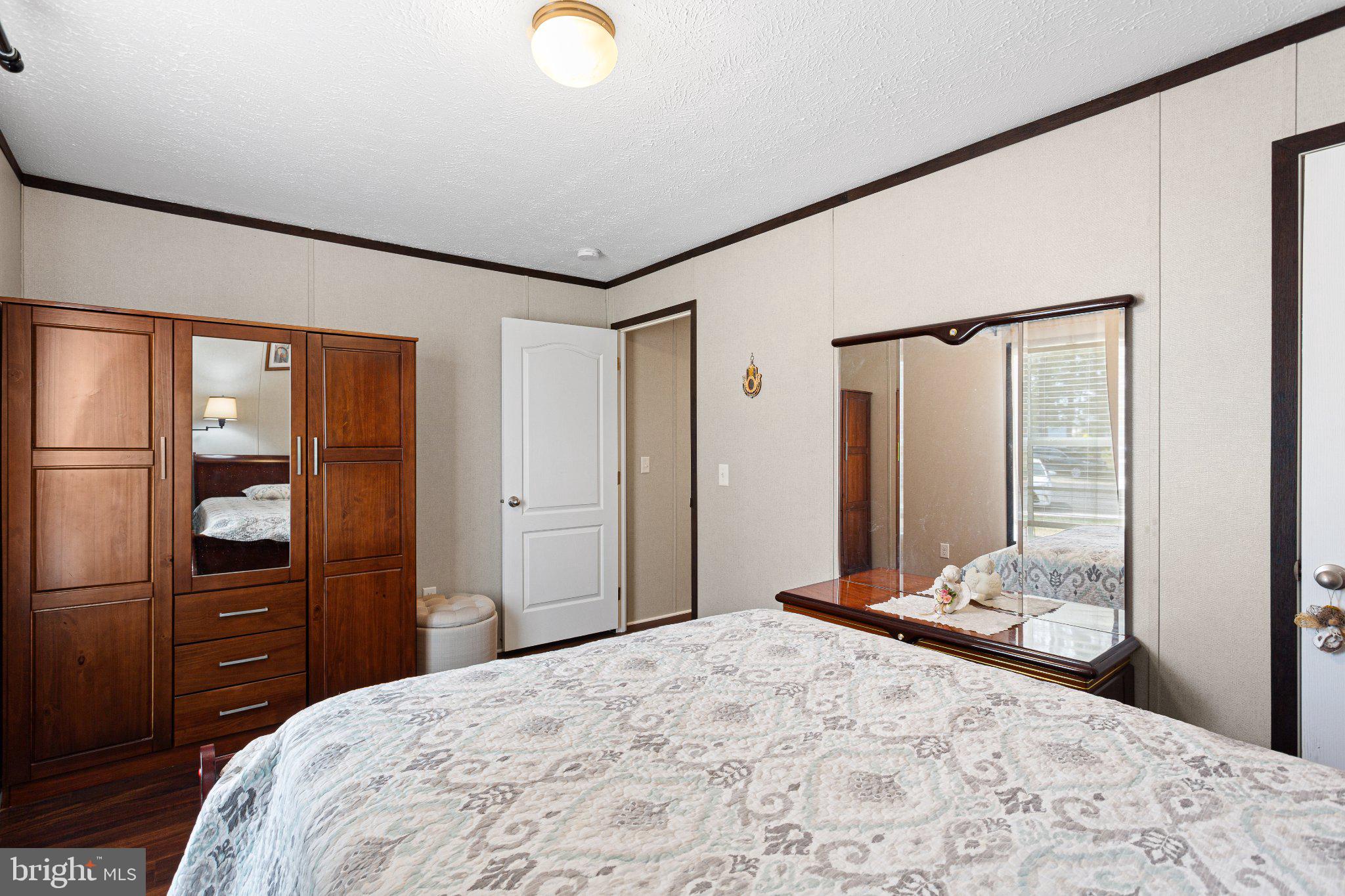 234 Iris Road Mullica Hill, NJ 08062 - Photo 12 of 15 Cozy bedroom with warm wood accents.