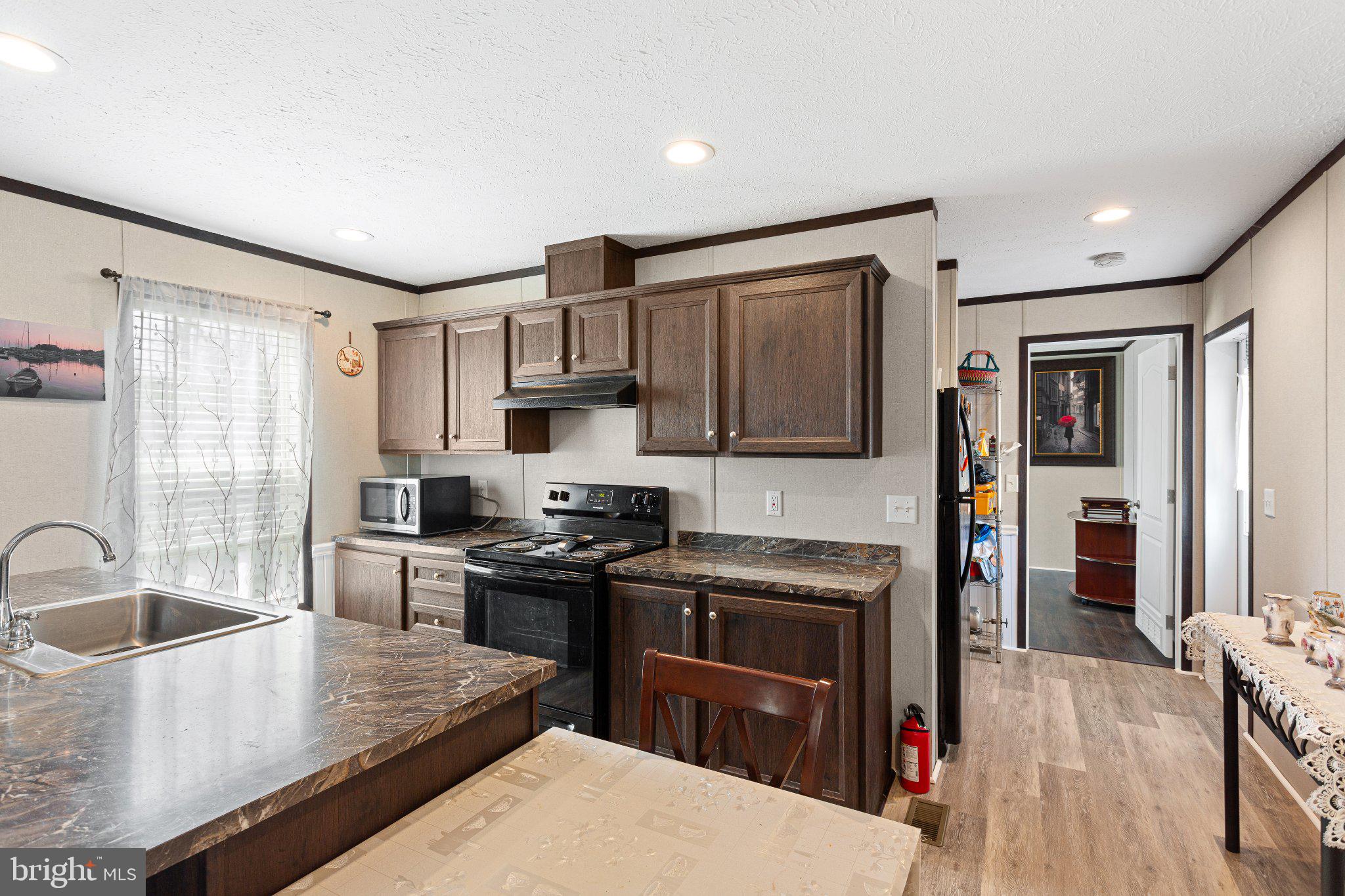 234 Iris Road Mullica Hill, NJ 08062 - Photo 4 of 15 Modern kitchen with warm wood tones.
