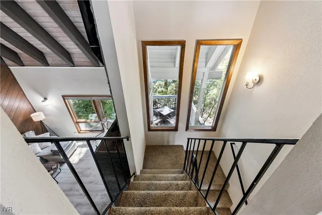 a bathroom with a granite countertop sink a mirror and shower