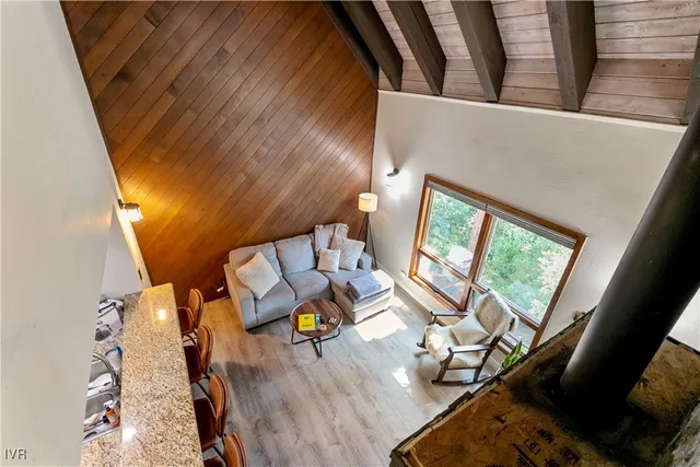 a view of a swimming pool with a bench and trees around