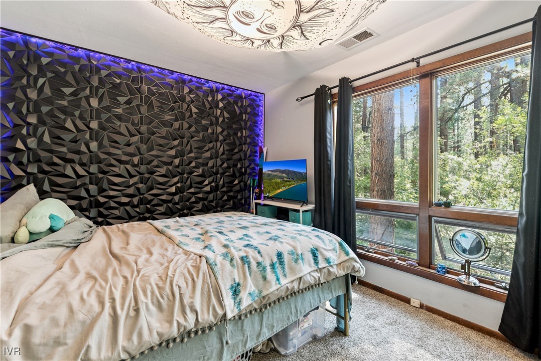 908 Harold Drive, Unit 23 Incline Village, NV 89451 - Photo 22 of 36 a bed sitting in a bedroom next to a window