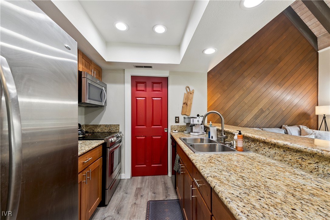 908 Harold Drive, Unit 23 Incline Village, NV 89451 - Photo 6 of 36 a kitchen with stainless steel appliances granite countertop a sink stove and refrigerator
