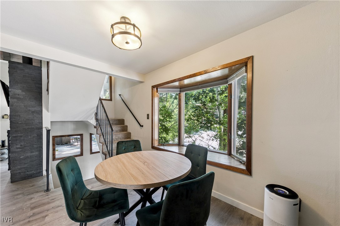 908 Harold Drive, Unit 23 Incline Village, NV 89451 - Photo 7 of 36 a view of a dining room with furniture window and wooden floor