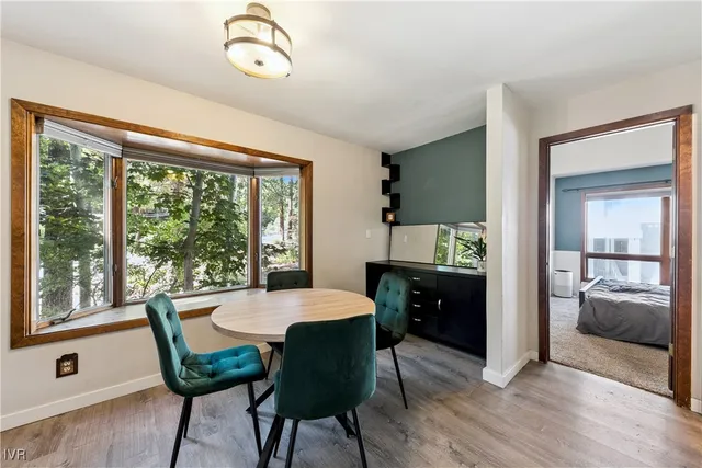 a bedroom with a bed and a flat tv screen on dresser