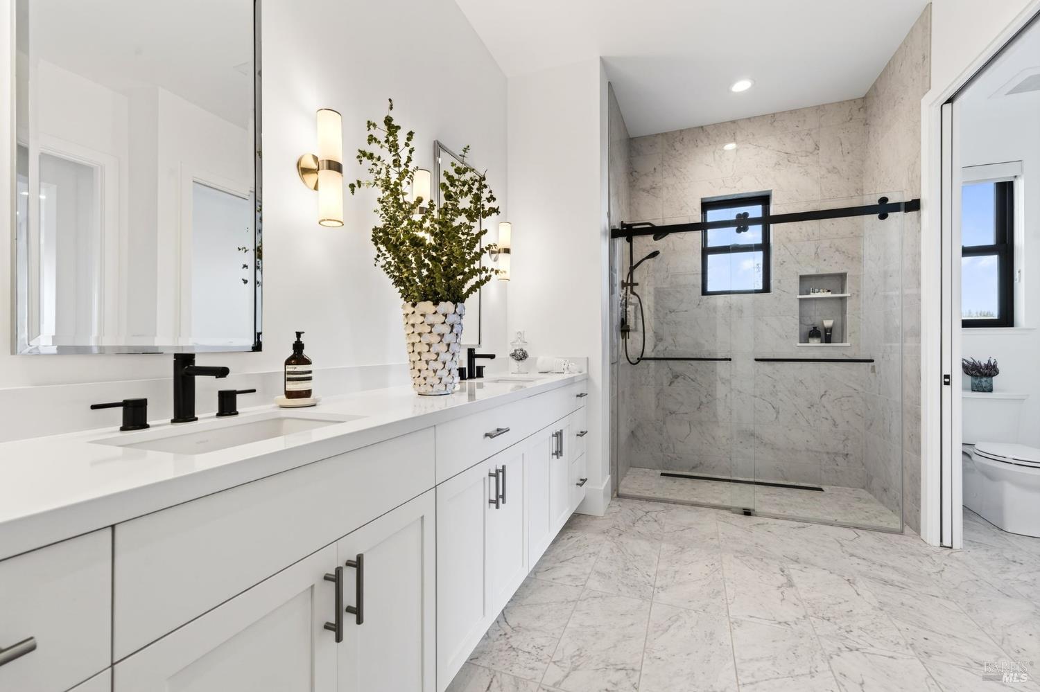 16 Upland Road St. Helena, CA 94574 - Photo 35 of 97 Beautiful marble tile surround and a trench drain add to the elegance of the downstairs primary suite.