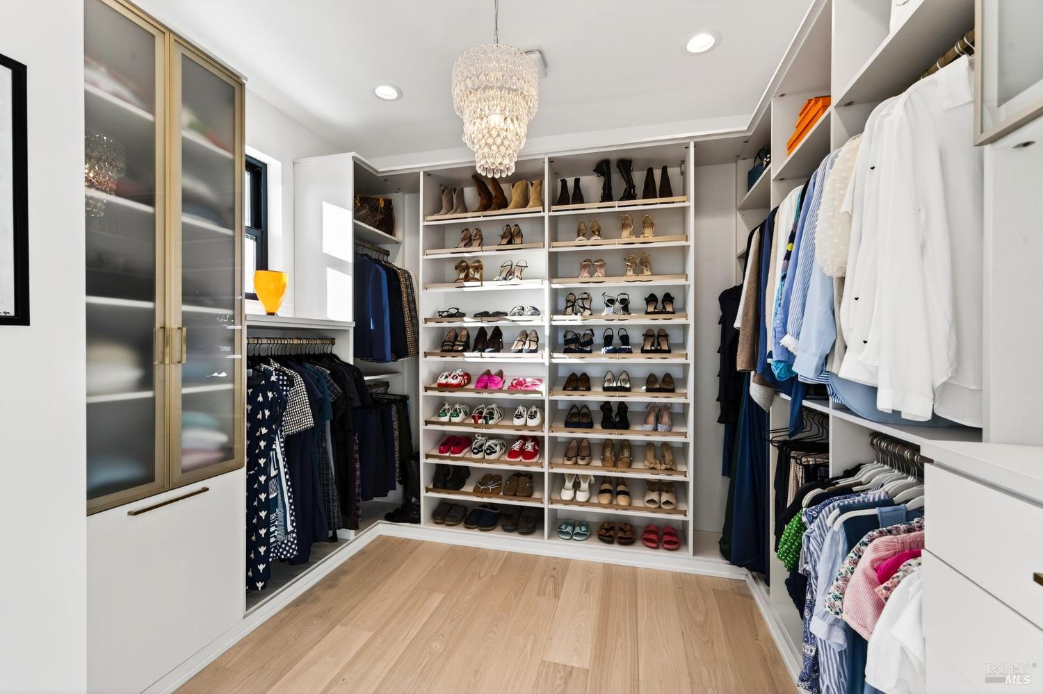 16 Upland Road St. Helena, CA 94574 - Photo 46 of 97 The Primary Her Closet with lots of shoe storage and a Restoration Hardware chandelier.
