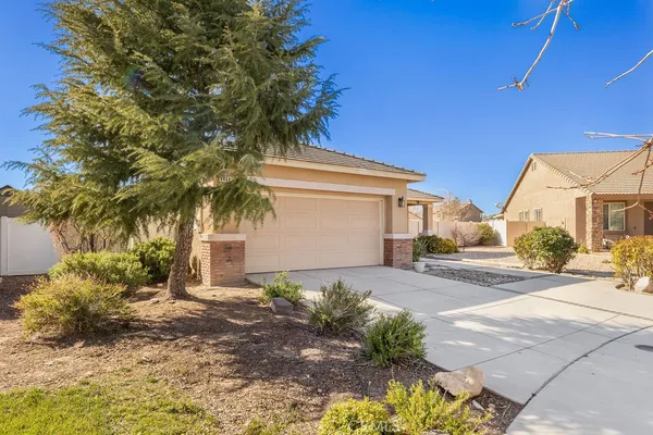 a front view of a house with a yard and a garage