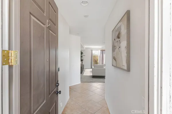 a view of a hallway with windows and closet