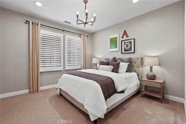 a bedroom with a bed and a couch