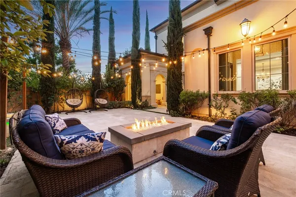 a view of a patio with couches table and chairs and potted plants