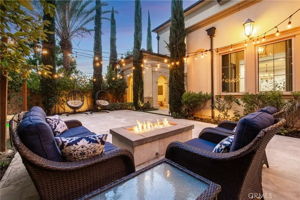 a view of a patio with a table and chairs and potted plants